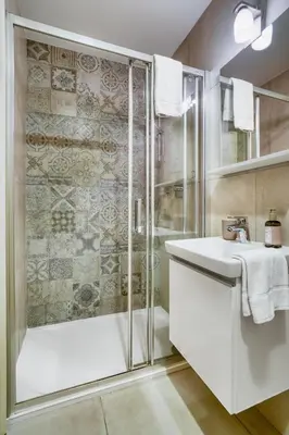a bathroom with a shower and a sink at Grébovka Parkside Apartment by Rentez in Prague