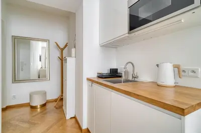 a kitchen with a sink and a counter top at Grébovka Parkside Apartment by Rentez in Prague