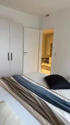 a bedroom with a bed with a black pillow on it at The Shalom in Prague