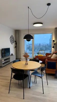 a living room with a table and chairs and a couch at The Shalom in Prague