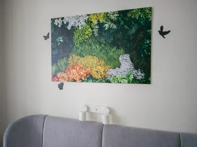 a painting hanging on a wall above a couch at Heart of Zizkov in Prague