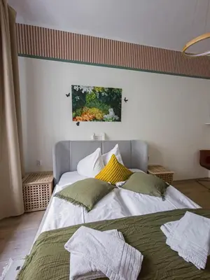 a bedroom with a large bed with pillows on it at Heart of Zizkov in Prague