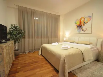 a bedroom with a bed and a painting on the wall at Apartment mit Terrasse by Interhome in Prague