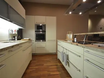 a kitchen with white cabinets and stainless steel appliances at Apartment mit Terrasse by Interhome in Prague
