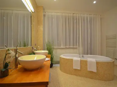 a bathroom with a large tub and a sink at Apartment mit Terrasse by Interhome in Prague
