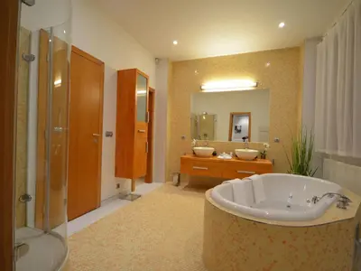 a large bathroom with a tub and a sink at Apartment mit Terrasse by Interhome in Prague