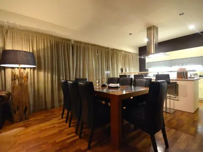 a dining room with a wooden table and black chairs at Apartment mit Terrasse by Interhome in Prague