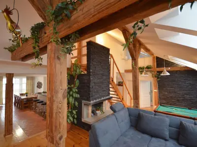 a living room with a couch and a fireplace at Apartment Wohnung Attic Josefov mit eigener Terrasse by Interhome in Prague