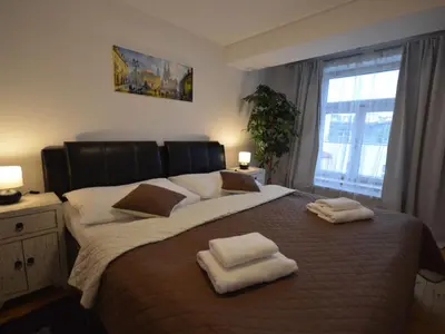 a bedroom with a large bed with towels on it at Apartment Wohnung Attic Josefov mit eigener Terrasse by Interhome in Prague