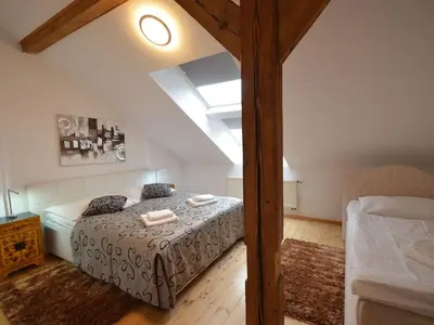 a bedroom with a large bed in a attic at Apartment Wohnung Attic Josefov mit eigener Terrasse by Interhome in Prague