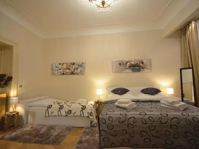 a bedroom with a bed and two paintings on the wall at Apartment Wohnung mit eigenem Balkon by Interhome in Prague