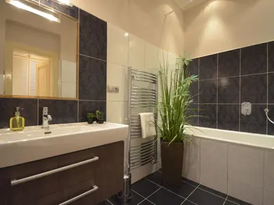 a bathroom with a sink and a tub and a mirror at Apartment Wohnung mit eigenem Balkon by Interhome in Prague