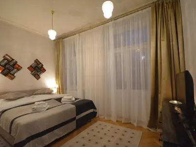 a bedroom with a bed and a window with curtains at Apartment Wohnung mit eigenem Balkon by Interhome in Prague