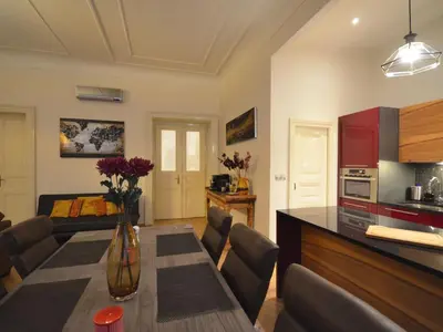 a kitchen and a living room with a table and chairs at Apartment Wohnung mit eigenem Balkon by Interhome in Prague