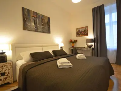 a bedroom with a bed with two towels on it at Apartment Collection Hastalska by Interhome in Prague