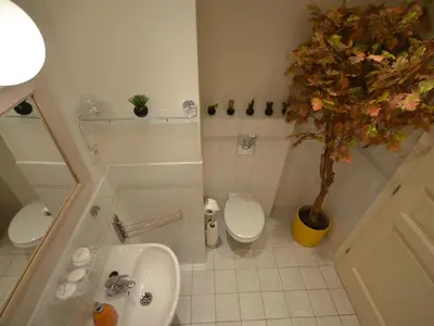 a bathroom with a sink and a toilet and a tree at Apartment Collection Hastalska by Interhome in Prague