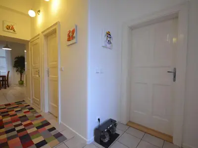 a hallway with a white door and a rug at Apartment Collection Hastalska by Interhome in Prague