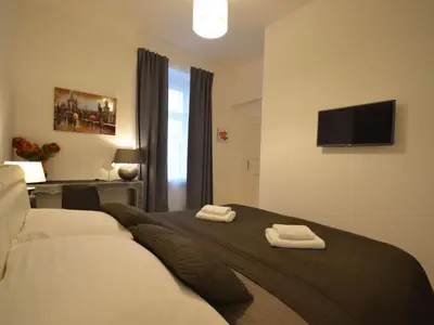 a bedroom with a bed with two towels on it at Apartment Collection Hastalska by Interhome in Prague