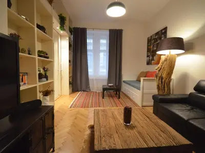 a living room with a couch and a table at Apartment Collection Hastalska by Interhome in Prague