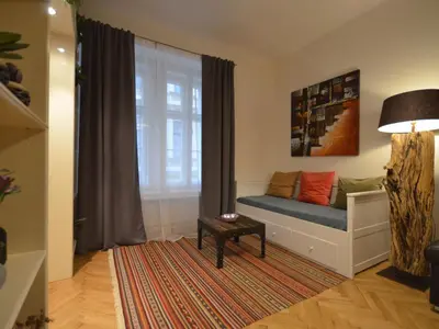 a living room with a couch and a window at Apartment Collection Hastalska by Interhome in Prague