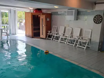 a swimming pool with chairs and a table and some water at Holiday Home Komfortvilla in Prag- Hallenbad- Whirlpool- Sauna by Interhome in Vranov