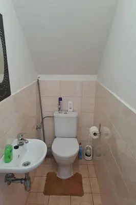 a bathroom with a white toilet and a sink at Holiday Home Komfortvilla in Prag- Hallenbad- Whirlpool- Sauna by Interhome in Vranov