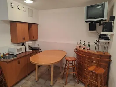 a kitchen with a table and a small table and chairs at Holiday Home Komfortvilla in Prag- Hallenbad- Whirlpool- Sauna by Interhome in Vranov
