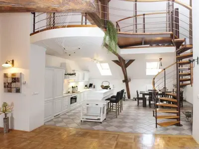 a kitchen and dining room with a spiral staircase at Apartment Apartment mit Waschmaschine und Geschirrspüler by Interhome in Prague