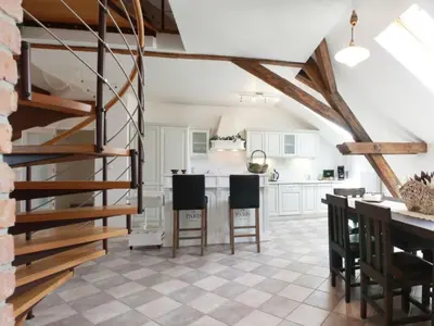 a kitchen with white cabinets and a spiral staircase at Apartment Apartment mit Waschmaschine und Geschirrspüler by Interhome in Prague