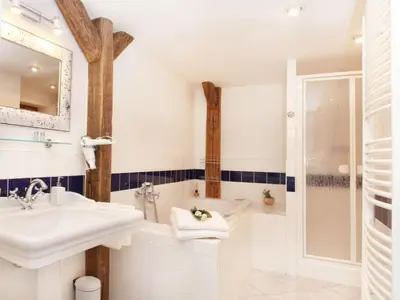 a white bathroom with a sink and a shower at Apartment Apartment mit Waschmaschine und Geschirrspüler by Interhome in Prague