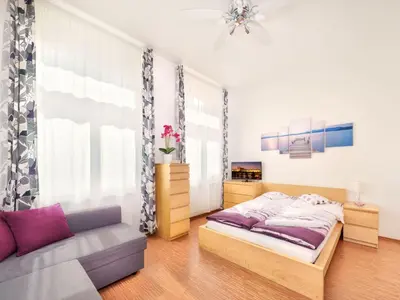 a bedroom with two beds and a couch at Apartment Paradies-Wohnung by Interhome in Prague