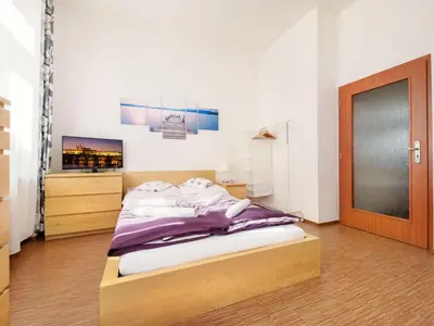 a bedroom with a bed and a tv on the wall at Apartment Paradies-Wohnung by Interhome in Prague