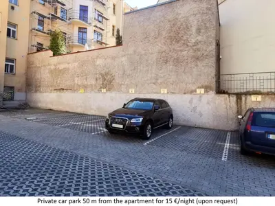 a car parked in a parking lot next to a wall at Apartment Paradies-Wohnung by Interhome in Prague