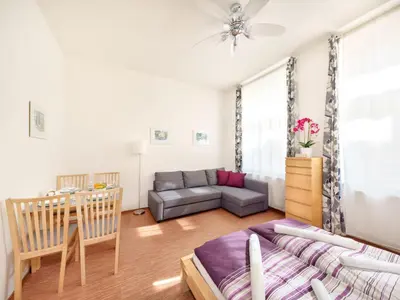 a living room with a couch and a table at Apartment Paradies-Wohnung by Interhome in Prague
