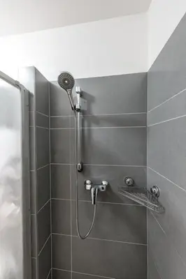 a shower with a shower head in a bathroom at Apartment Paradies-Wohnung by Interhome in Prague
