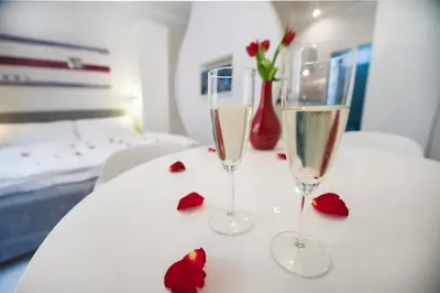 two glasses of champagne and roses on a table at Honeymoon Ruterra studio in Prague