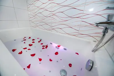 a bath tub with hearts on the side of it at Honeymoon Ruterra studio in Prague