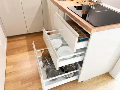 a kitchen with an open drawer with plates and dishes at Modern Žižkov apartment in the center in Prague
