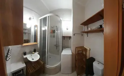 a bathroom with a shower and a toilet and a sink at ANDĚL apartment VLTAVA' SPIRIT - Smíchov in Prague