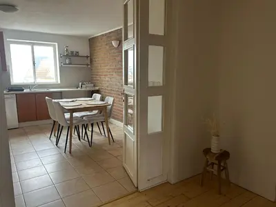 a kitchen and dining room with a table and chairs at Náměstí Míru 13 in Prague