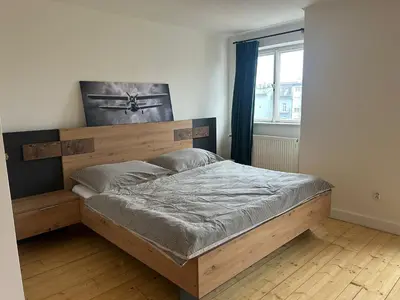 a bedroom with a wooden bed in a room at Náměstí Míru 13 in Prague