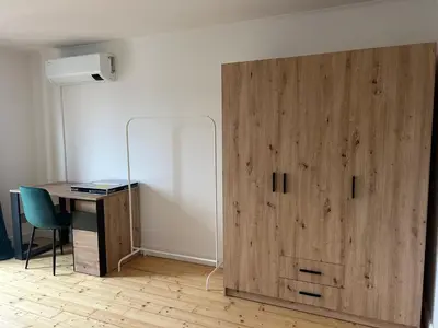 a large wooden door in a room with a desk and a desk at Náměstí Míru 13 in Prague