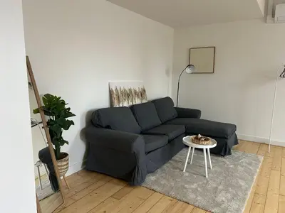 a living room with a blue couch and a table at Náměstí Míru 13 in Prague
