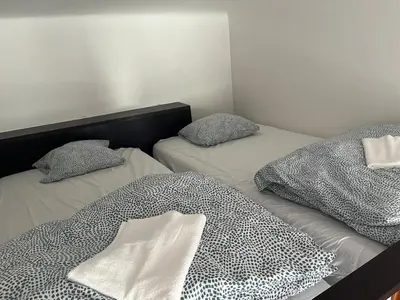 two twin beds with pillows in a room at Central cozy rooms Soukenická S32 in Prague