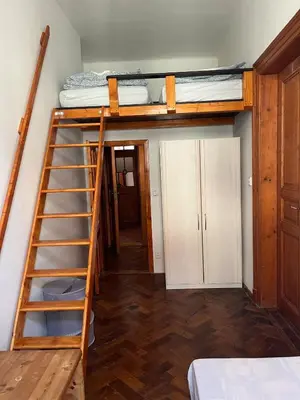 a room with two bunk beds and a ladder at Central cozy rooms Soukenická S32 in Prague
