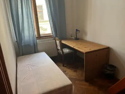 a cobblestone street in a city with cars and buildings at Central cozy rooms Soukenická S32 in Prague
