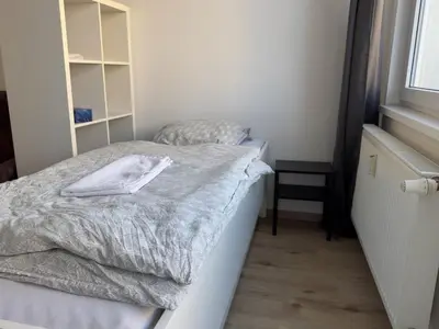 a small bedroom with a bed with a gray comforter at Smart Studio for Work & City Exploring in Prague