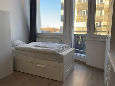 a small bed in a room with a window at Smart Studio for Work & City Exploring in Prague