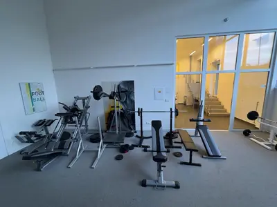 a gym with several treadmills and machines in a room at Smart Studio for Work & City Exploring in Prague