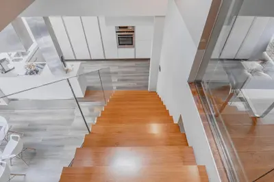 a staircase in a home with white walls and wood floors at Luxury Apartment in Centre in Prague